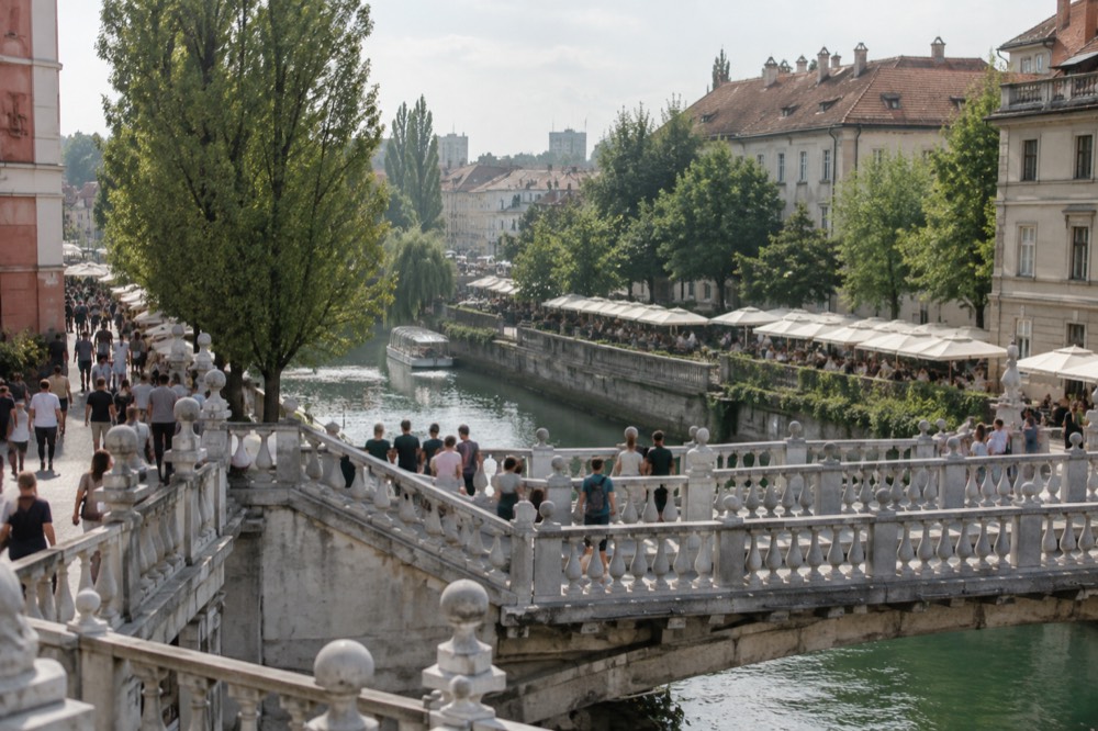 The Triple Bridge and riverside market stalls along the Ljubljanica in Ljubljana