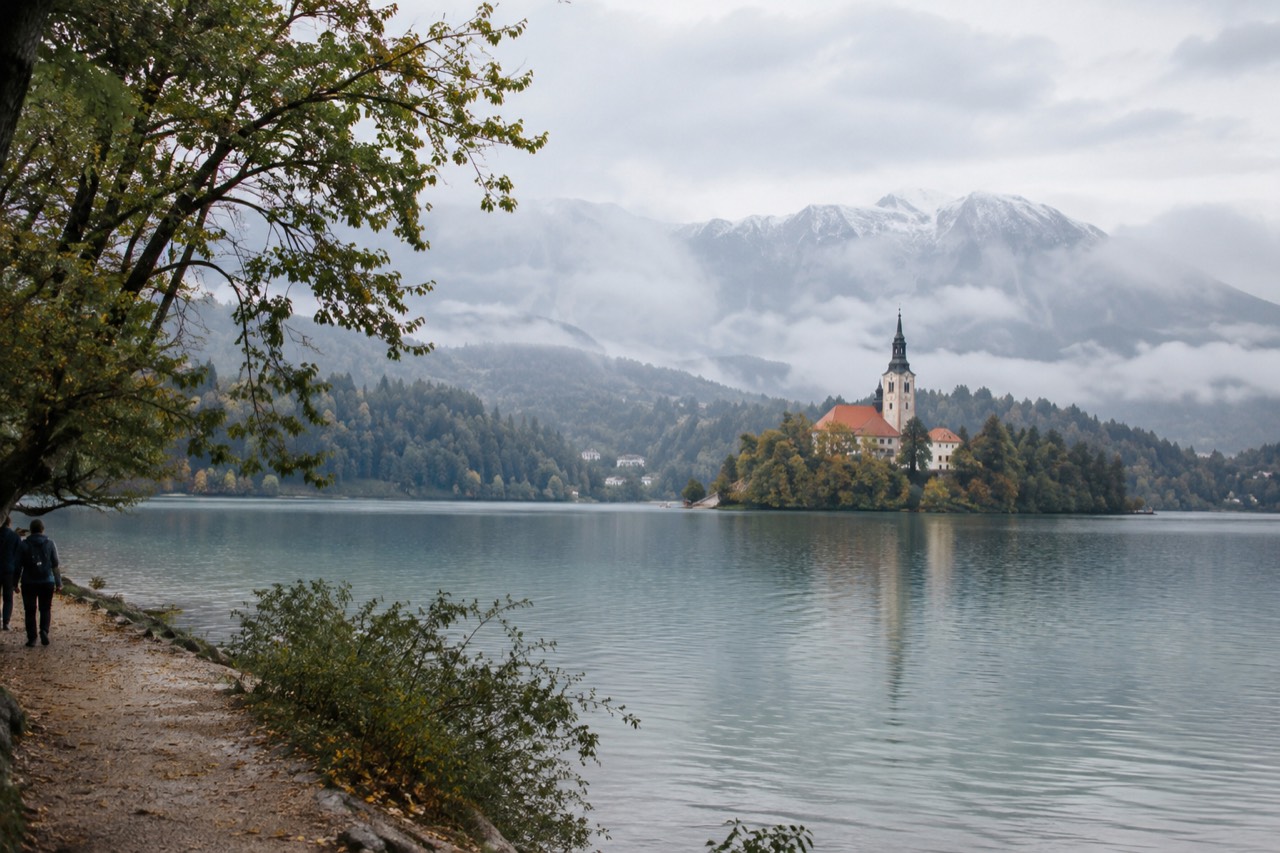 Lake Bled seen from the shore path with the island church and forested hills
