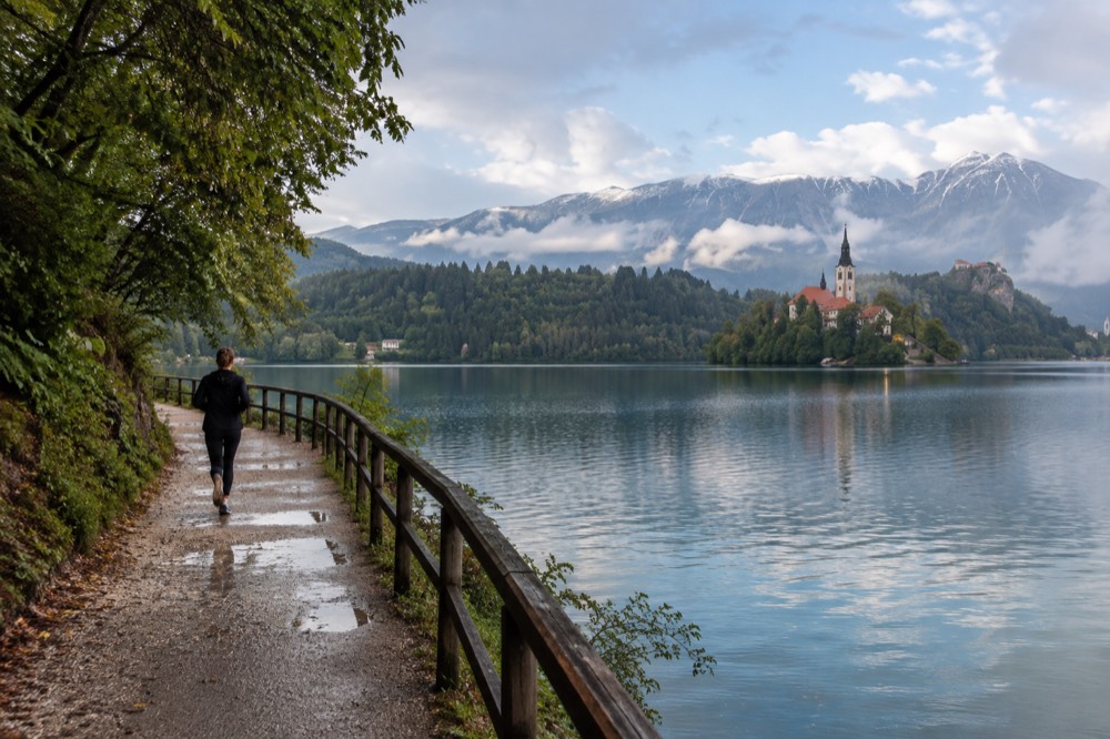 Lake Bled with the island church and forested shore under morning light