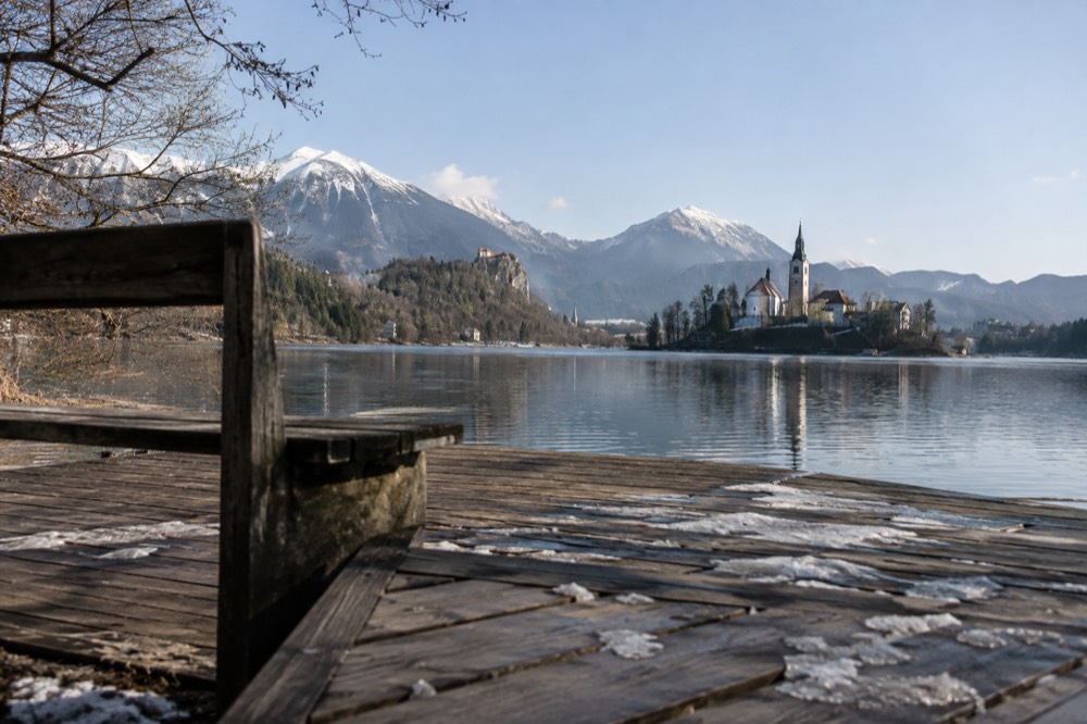 Lake Bled with its island church and forested shores under a clear sky