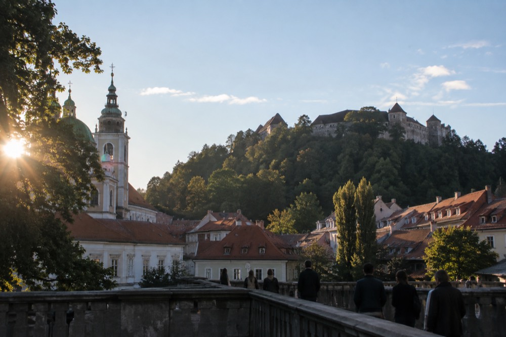 The Ljubljana Castle hill rising above the rooftops seen from near the church