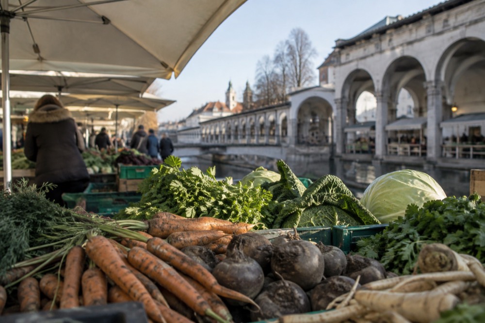 Riverside market colonnades with stone arches along the Ljubljanica