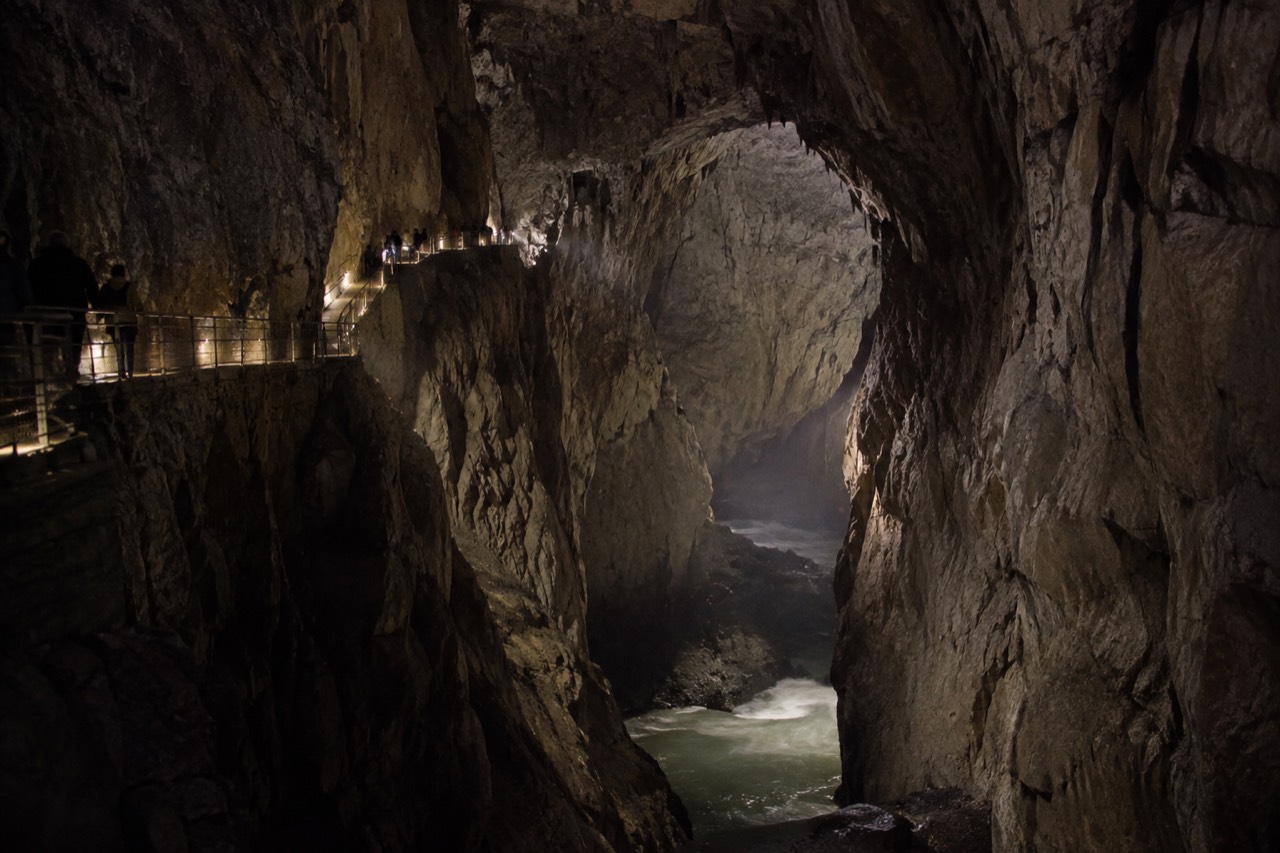 The vast underground canyon of the Škocjan Caves with a walkway suspended above the river