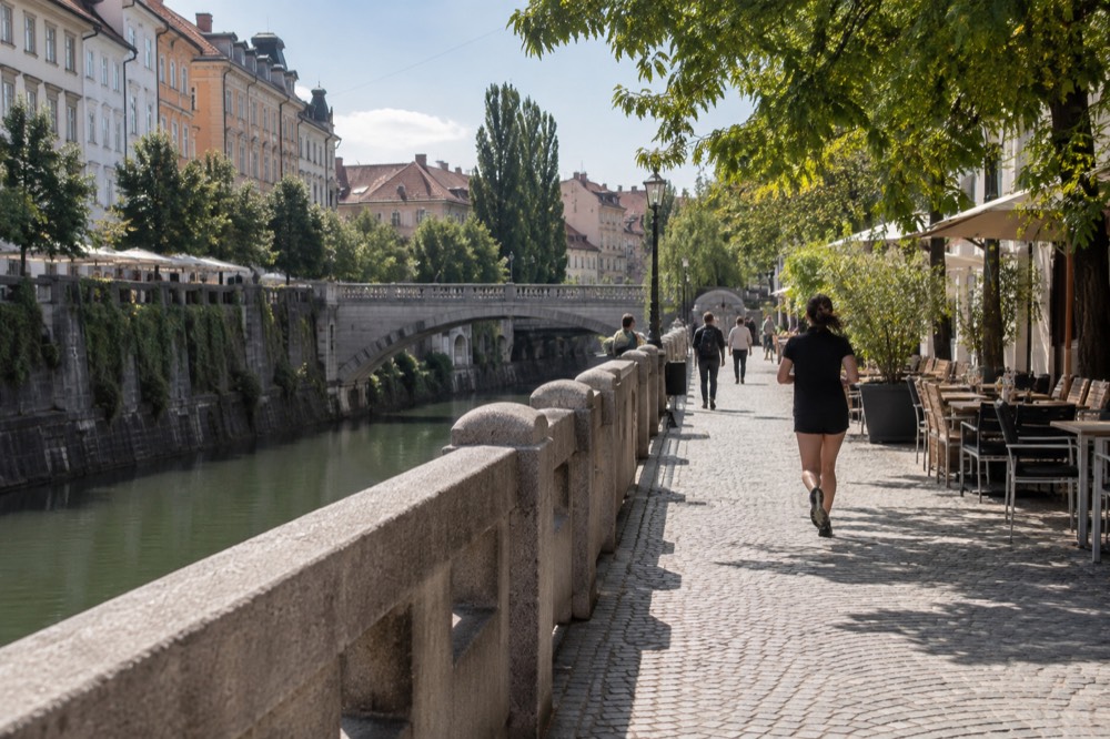 The pedestrianised riverside embankment of the Ljubljanica in central Ljubljana on a bright morning