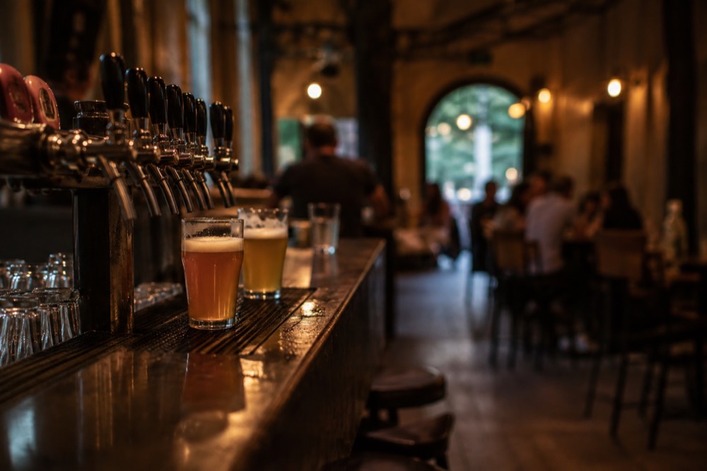 Craft beer taps and glasses on a counter in a Ljubljana taproom
