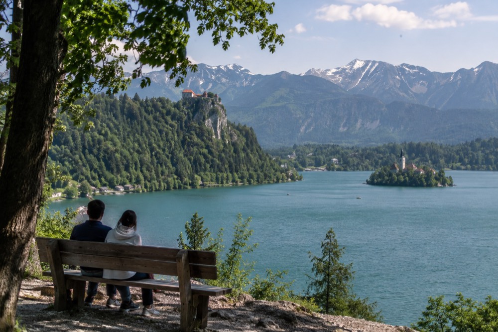 Bled Castle on a cliff above the lake with the island church in the distance