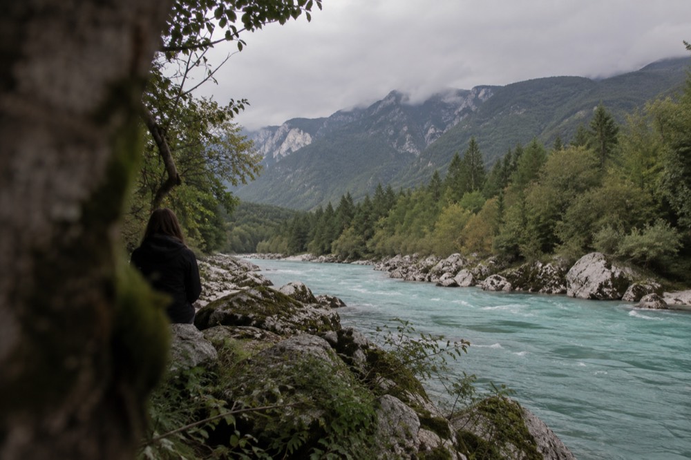 The turquoise Soča river running through a wide alpine valley