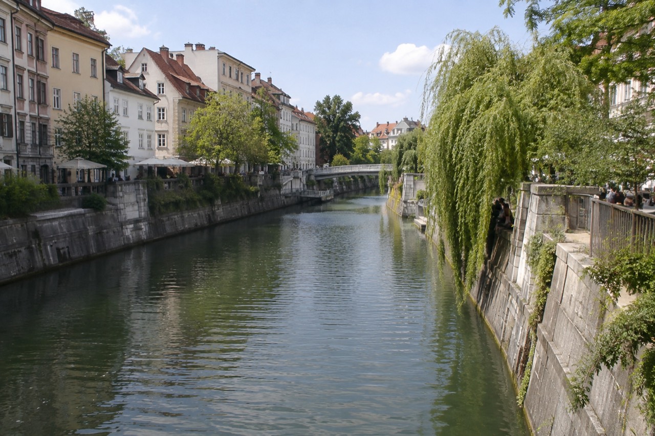 Pastel buildings and riverside walkways along the Ljubljanica in central Ljubljana