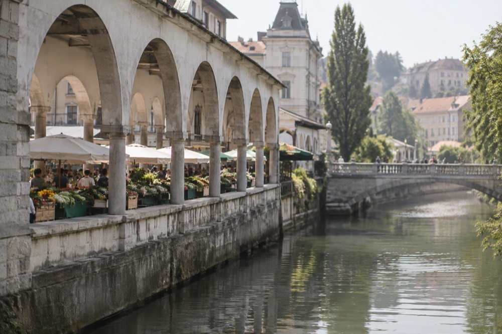 Covered market hall in Ljubljana with produce stalls under the colonnade